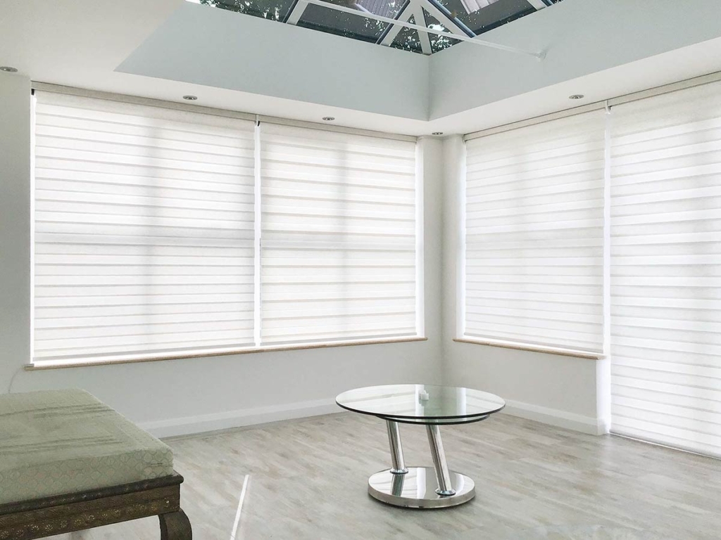 Japandi Duo Roller Blinds in a conservatory.