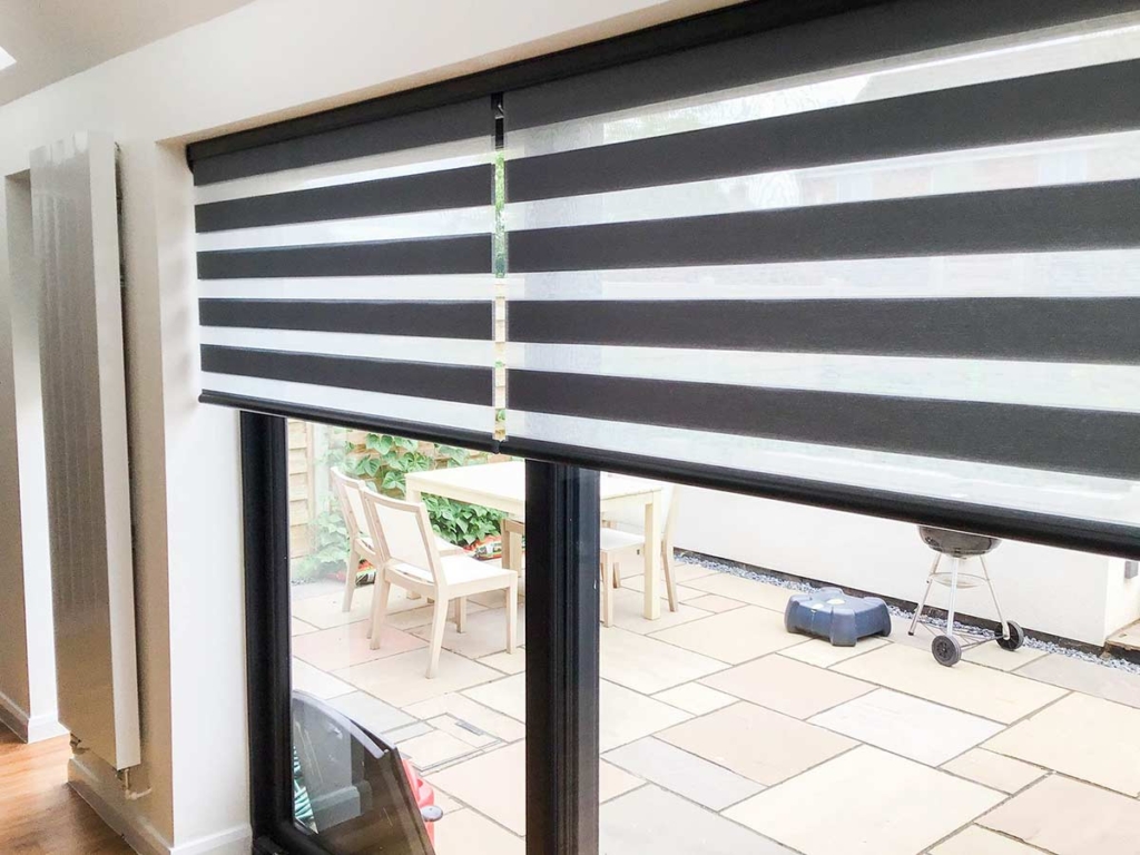 Japandi Duo Roller Blinds over a set of doors.