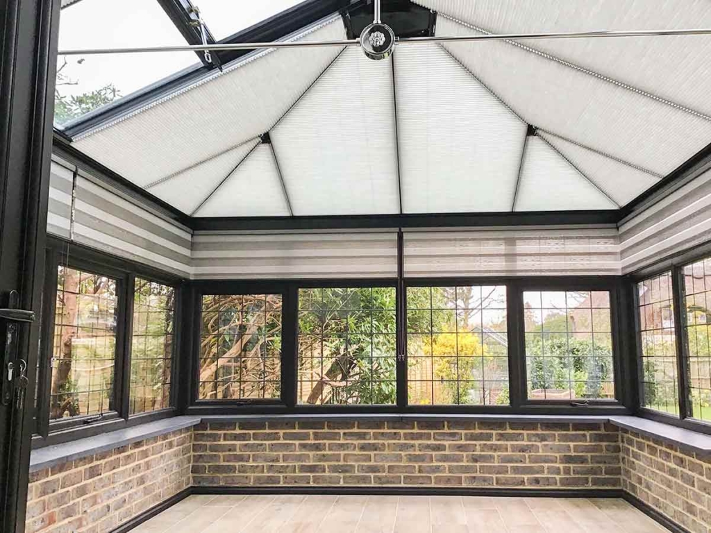 Japandi Duo Roller Blinds in a conservatory.